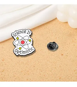 Detail view of enamel science brooch with atom design and Science Is Optimistic text