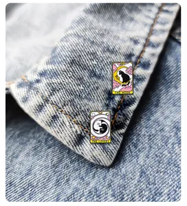 Detail of tarot cat enamel pins featuring The Moon and The Lovers on denim fabric