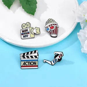 Creative cinema enamel pin set including popcorn, camera, and 3D glasses designs