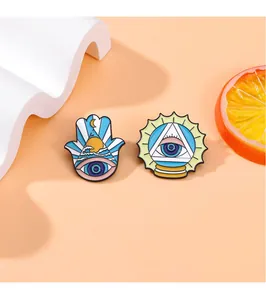 Detailed view of enamel eye brooches with sun and moon motifs on a stylized background