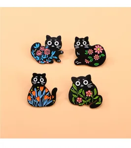 Detailed set of four black cat enamel pins featuring colorful floral patterns on metal