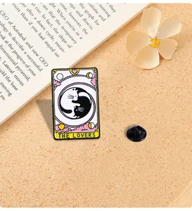 Detailed macro shot of Yin Yang cat enamel pin with Tarot The Lovers text and rubber clasp