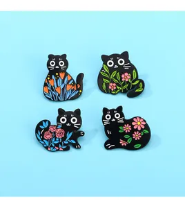 Set of four black cat enamel pins featuring colorful floral designs on a light blue background