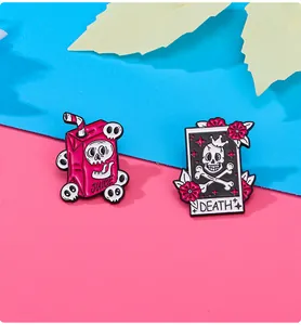 Detail of punk pink juice box and tarot skull enamel pins for Halloween bags