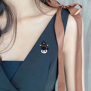 Halloween black cat enamel pin with wizard hat and skull shown on clothing