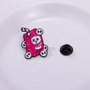 Detailed macro view of a pink punk skeleton juice box enamel pin with alloy drip oil finish