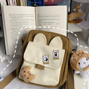 Cat tarot enamel pins on a stylish beige and brown canvas crossbody bag with cute ears