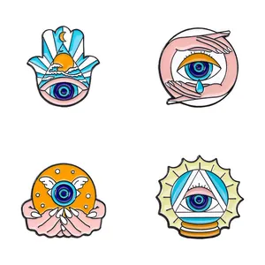 Artistic blue eye enamel lapel pins set with Hamsa hand and celestial moon designs