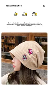 Pink skull juice box and Death poker card pins attached to a beige knit beanie