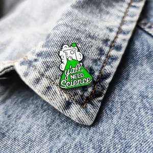Scientific conical flask enamel pin with y'all NEED Science text on denim jacket