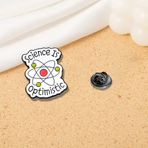 Creative Science Is Optimistic enamel pin with atom design and black butterfly clasp