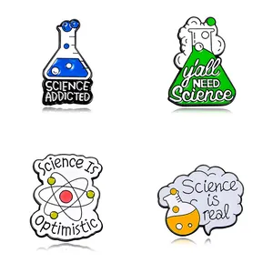 Set of four colorful science lab enamel pins with beakers and atom design for science lovers