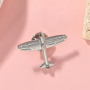 Macro detail of a silver vintage airplane brooch with metal butterfly clutch backing