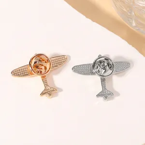 Detail view of gold and silver airplane pin backs with secure butterfly clutch fasteners
