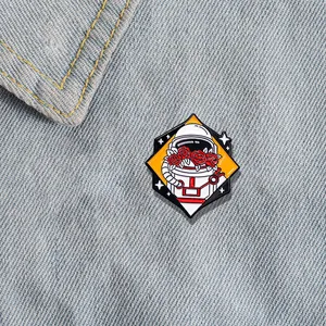 Astronaut helmet enamel pin with red roses on denim background, celestial themed accessory