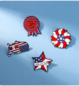 Flat lay of USA flag enamel pins set featuring July 4th motifs on light blue surface