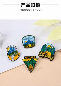 Set of four wilderness exploration enamel pins with mountain and forest themes