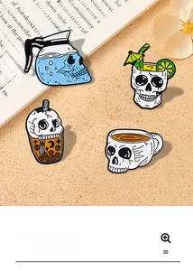 Close-up of creative skull enamel pins with coffee and cocktail themes on sand background