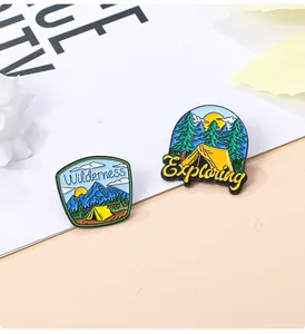 Detailed macro view of outdoor wilderness exploration enamel pins with pine trees and tents