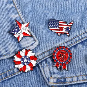 Detailed set of four July 4th enamel pins with USA flag motifs on blue denim background