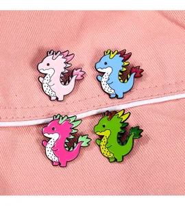 Detail of four colorful dragon brooches with pitaya fruit patterns on pink fabric