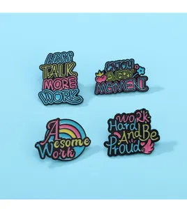 Set of 4 colorful enamel pins with motivational quotes like Less Talk More Work on blue background