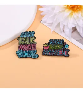 Macro detail of colorful enamel pins with motivational quotes on warm decorative background