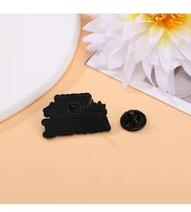 Close-up of the back of a black enamel pin featuring textured finish and rubber backings
