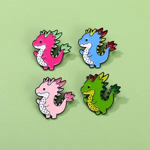 Set of four colorful dragon enamel pins with dragon fruit motif on a green background