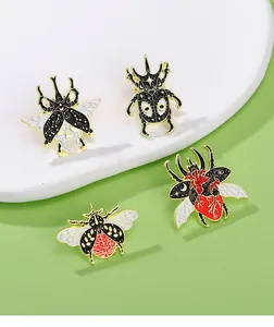 Close-up of creative insect enamel pins featuring skull, brain, and heart anatomical details