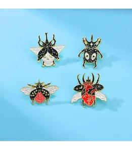 Detailed view of gothic insect enamel pins featuring anatomical skull and heart motifs