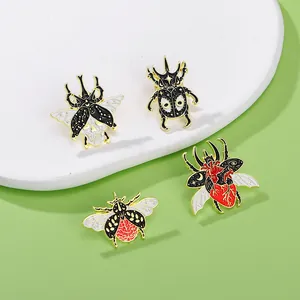 Detailed trio of gothic beetle enamel pins featuring skull, heart, and star patterns