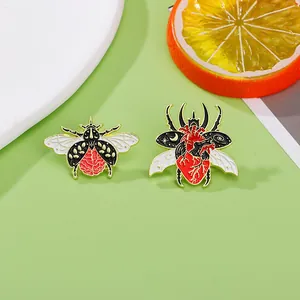 Macro shot of creative insect pins with brain and heart enamel details on a green backdrop