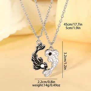 Detail showing dimensions of Yin Yang koi fish pendants with dimensions in cm and inches
