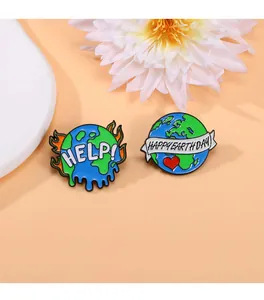 Detail view of Earth Day enamel pins featuring Help and Happy Earth Day slogans