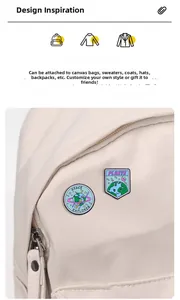 Detail of SPACE EXPLORER and planet enamel pins attached to a canvas backpack