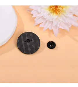Detailed back view of round enamel pin showing textured geometry and black butterfly clutch