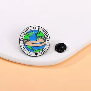Macro shot of Earth hug enamel pin with I'd like to give the world a hug text and back clasp