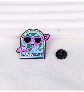 Detail view of cartoon Earth enamel pin with UNIVERSE text and rubber clutch backing