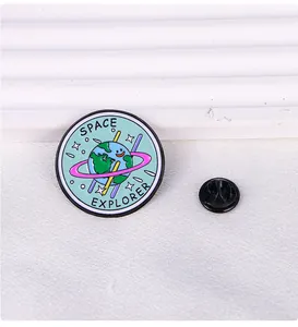 Detailed close-up of a blue enamel earth pin badge featuring Space Explorer engraving