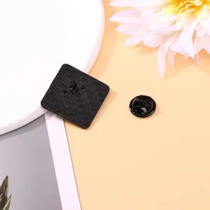 Black metal cartoon badge back view with honeycomb texture and butterfly clutch fastener