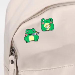 Funny cartoon frog enamel pins with dagger fixed on a beige canvas backpack surface