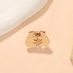 Detail of heart hands enamel brooch with gold-plated alloy and butterfly clasp back
