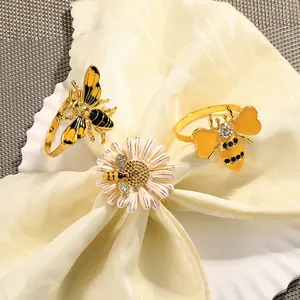 Juego de servilleteros de abeja dorada y margarita en aleación con esmalte y brillo