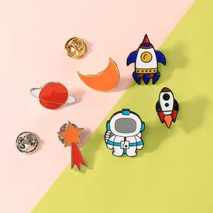 Cartoon astronaut enamel pins set featuring rocket moon star badges for bags and jackets