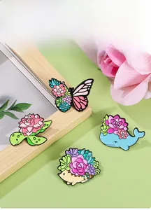 Detailed view of four colorful enamel pins featuring butterfly, turtle, whale and hedgehog
