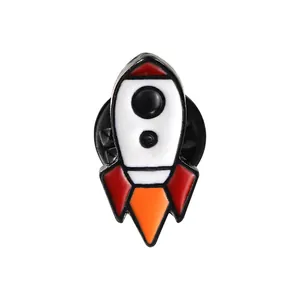 Detail view of cartoon rocket enamel pin with smooth metal edges and glossy finish