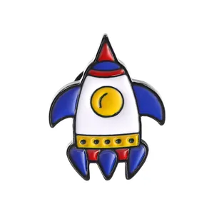 Close-up of a cartoon rocket enamel pin with vibrant red and blue colors on a white background
