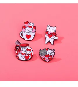 Detail view of four colorful enamel cat and heart pins with Full of Love text