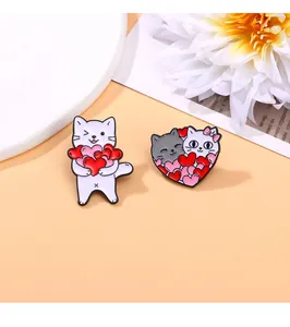 Close-up of cute cartoon cat enamel pins with hearts in vibrant red and white finishes
